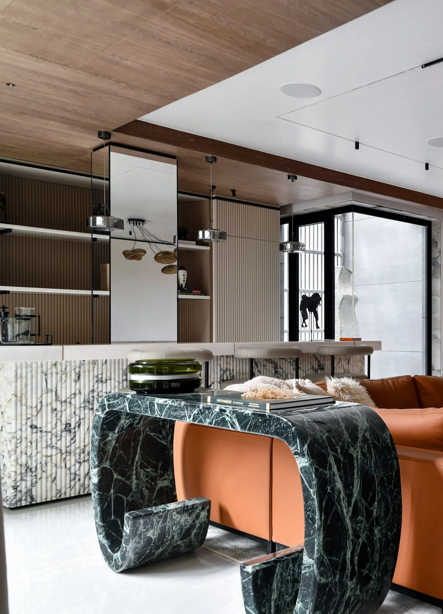 Art Deco inspired glamorous living room with gold details and dramatic furniture