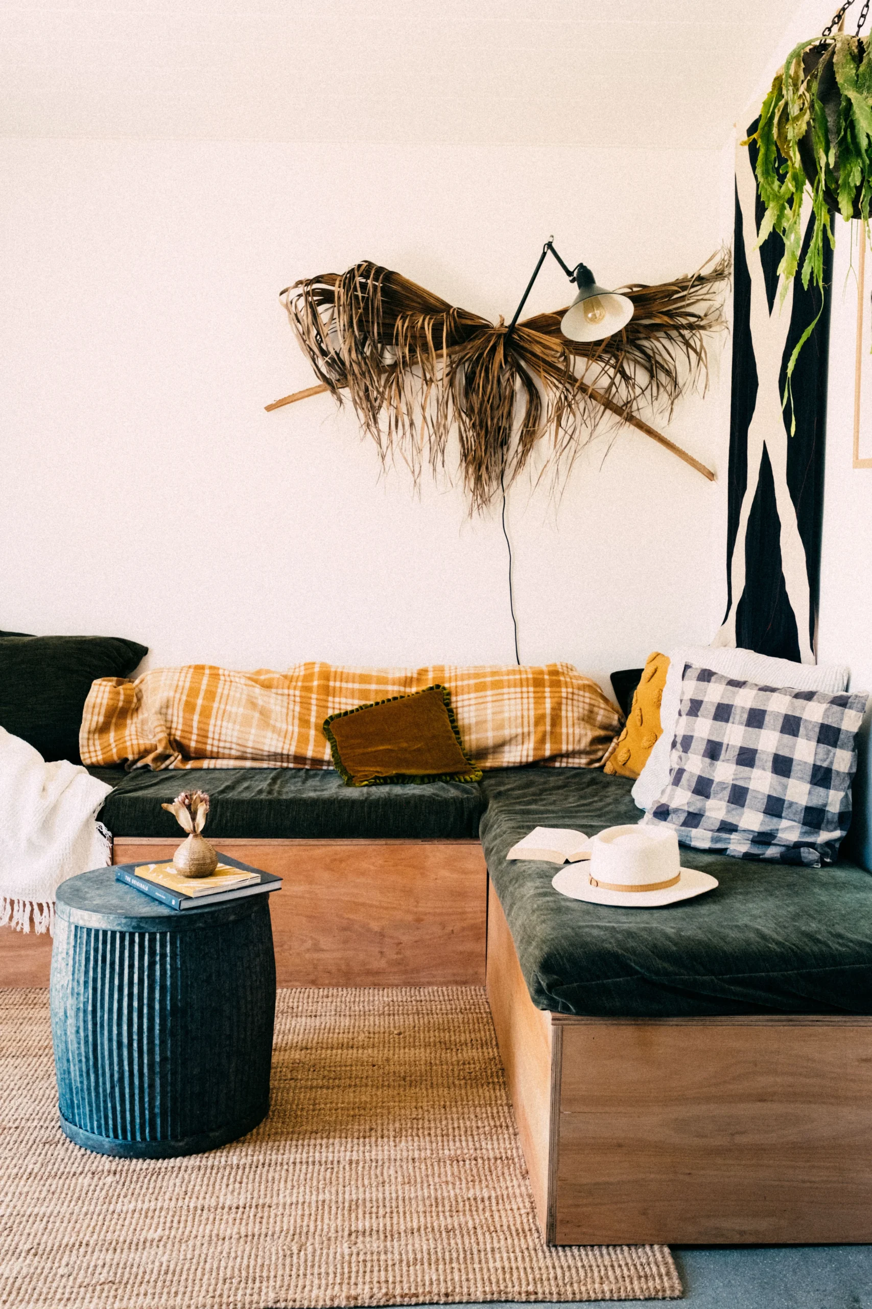 Colorful eclectic living room with layered textiles, plants and mixed decor