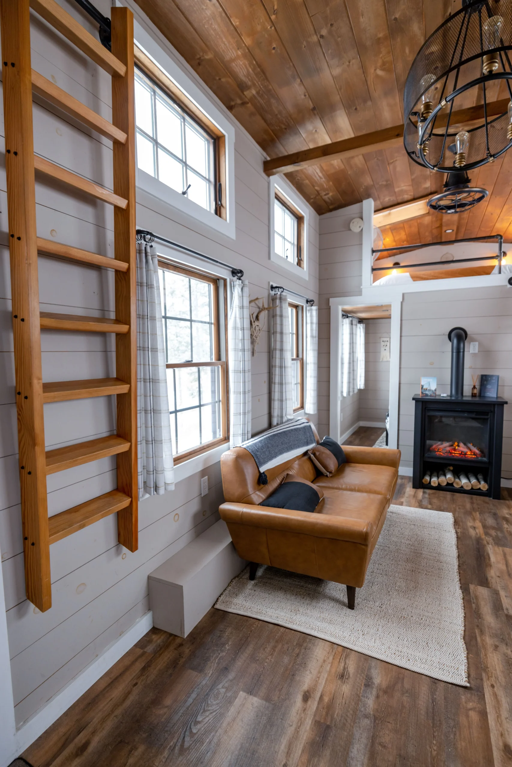 Cozy English cottage inspired living room with rustic furniture and layered textiles