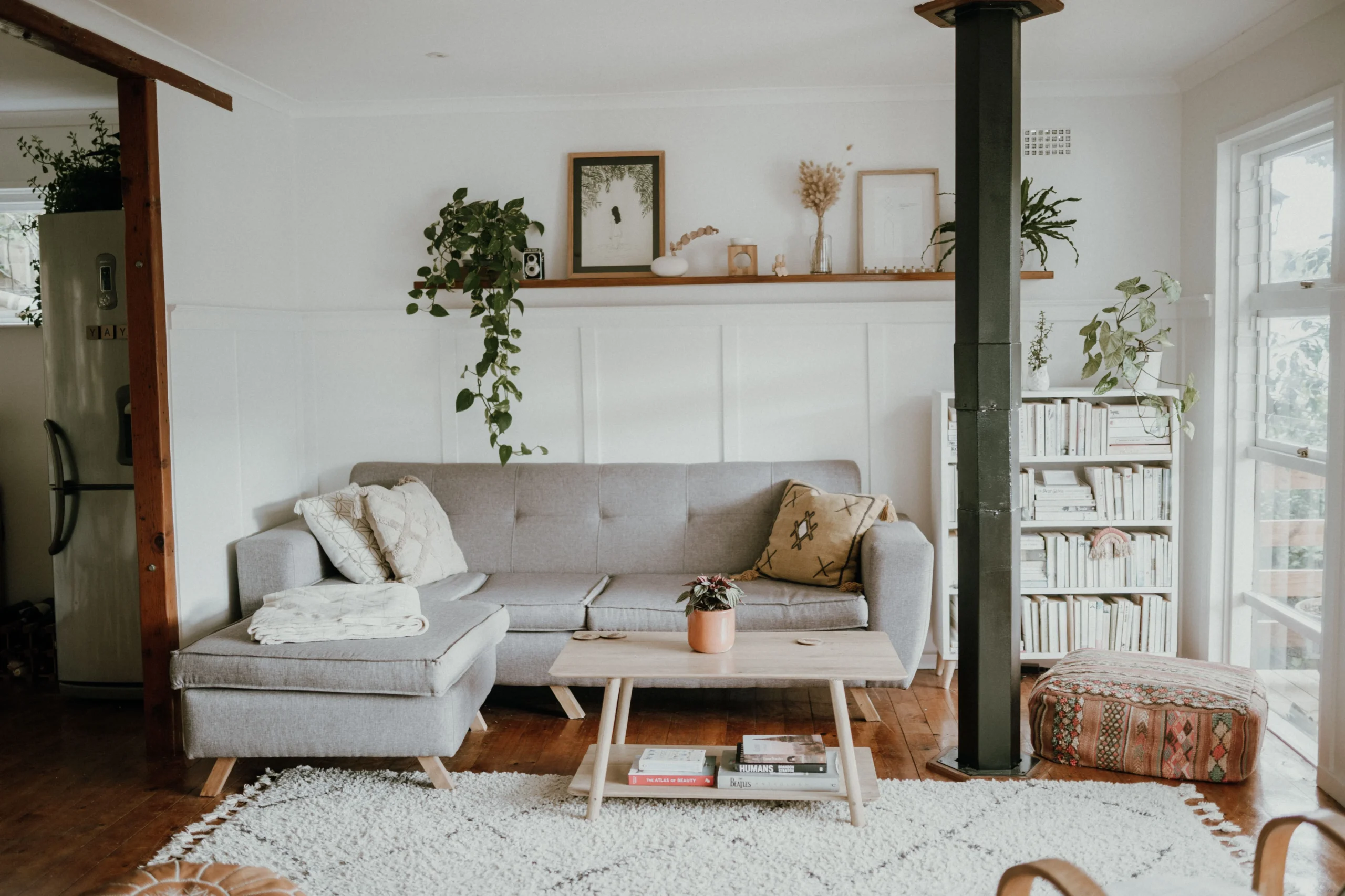 Scandinavian living room with light neutral colors, simple furniture, natural wood and plants