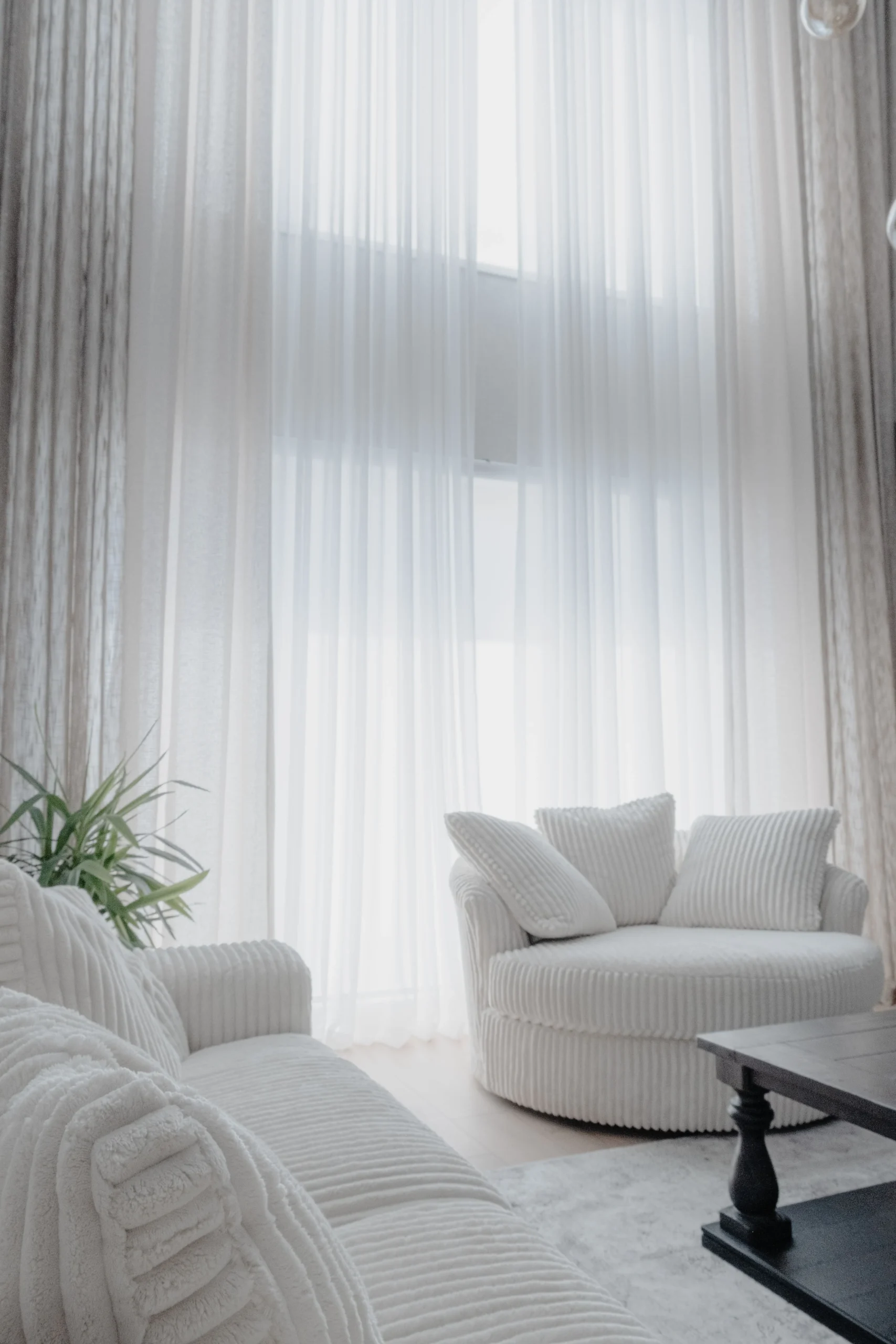 Tall floor-length curtains in an elegant neutral living room